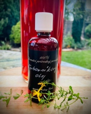 A bottle of liquid next to a plant

Description automatically generated